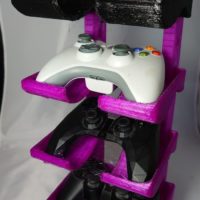 3D printed game controller stand with selection of controllers